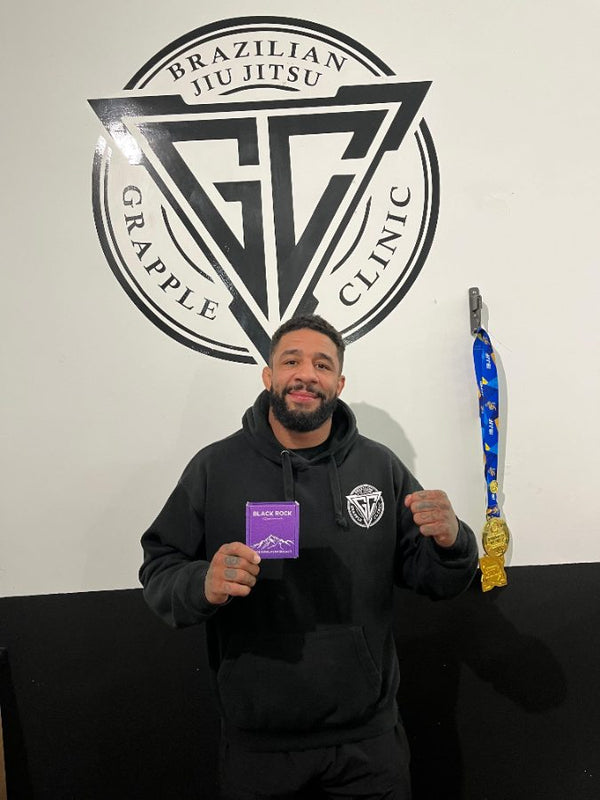 Customer holding a Black Rock box at a jiu jitsu gym