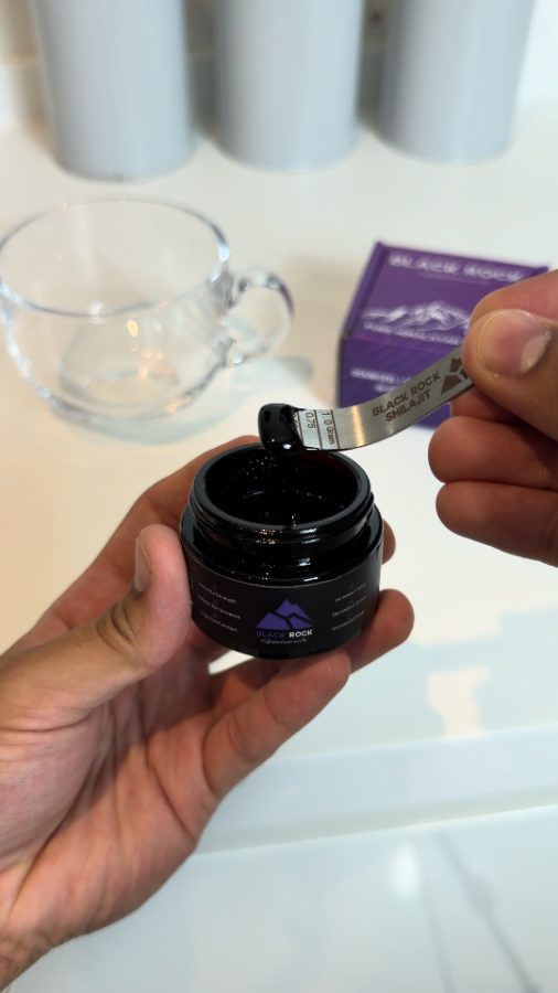 Customer opening a jar of Black Rock Shilajit resin
