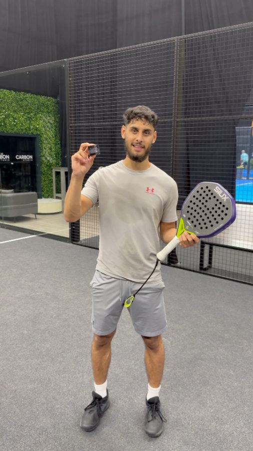Customer holding a Black Rock jar on a padel court