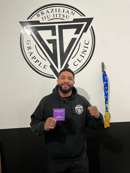 Customer holding a Black Rock box at a jiu jitsu gym